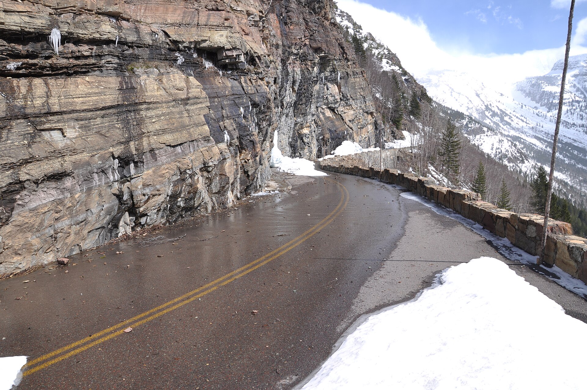 Going-to-the-Sun Road — The road above the Loop — cut into the cliff, stone guardwall on the drop side