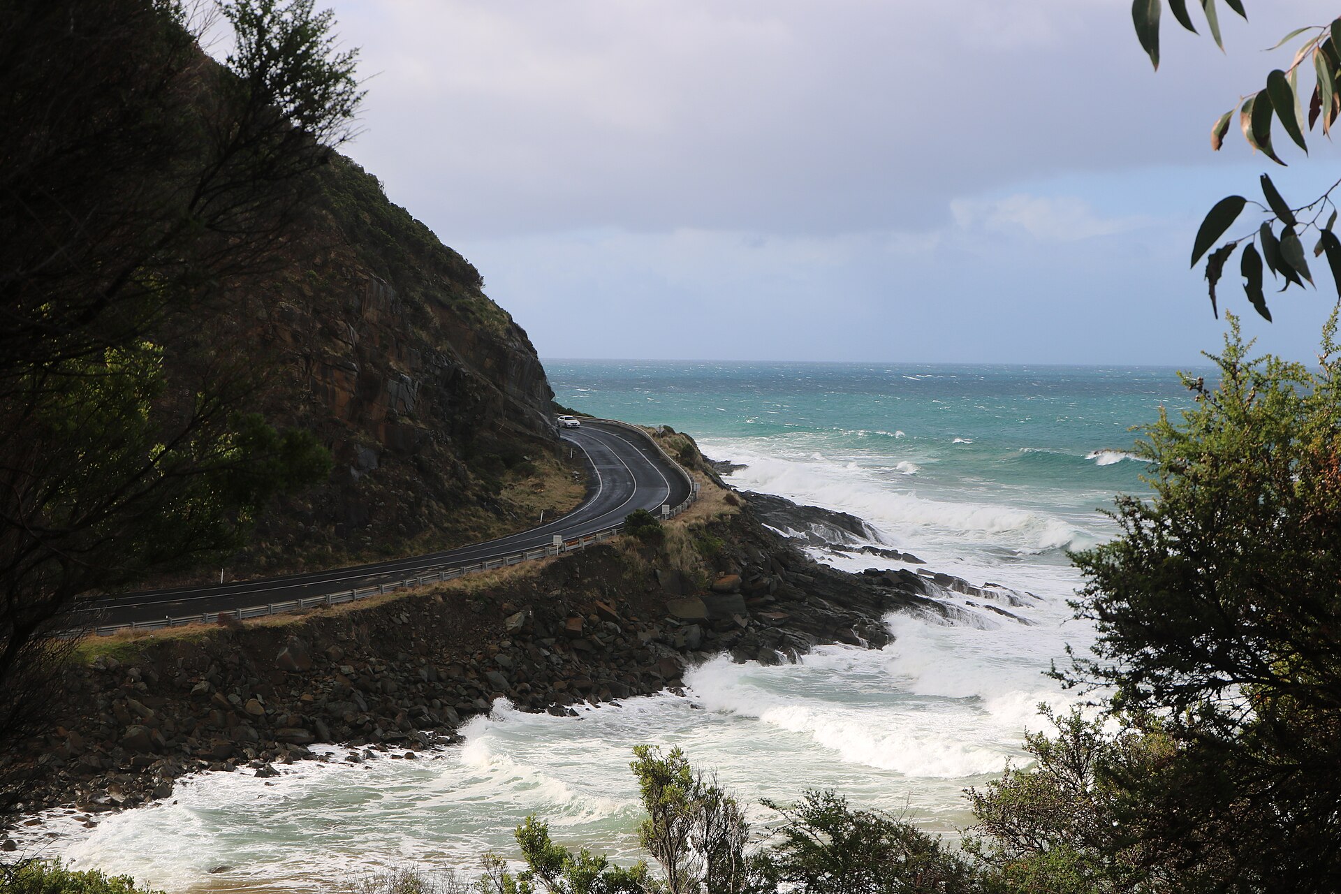 Great Ocean Road — The road itself, bending along the cliff base with the surf below